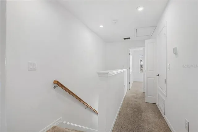 a view of a hallway with white walls