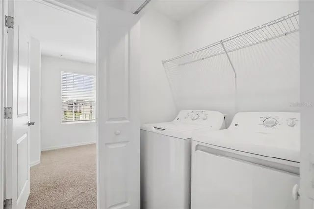 a view of storage and utility room with washer and dryer