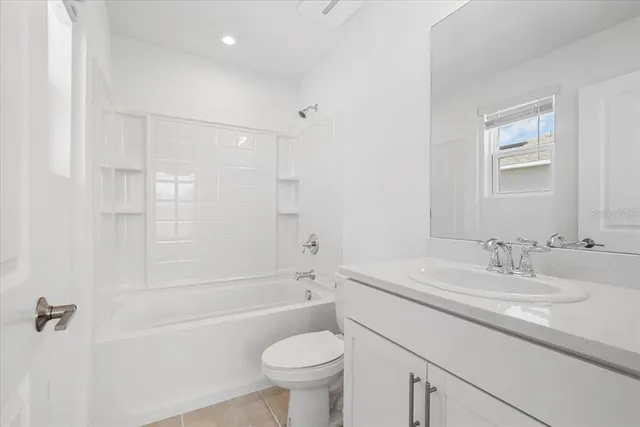 a bathroom with a sink toilet vanity and shower