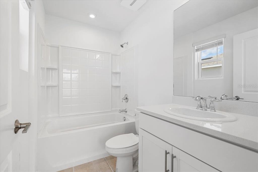 6338 Fairmont Lane Palmetto, FL 34221 - Photo 24 of 39 a bathroom with a sink toilet vanity and shower