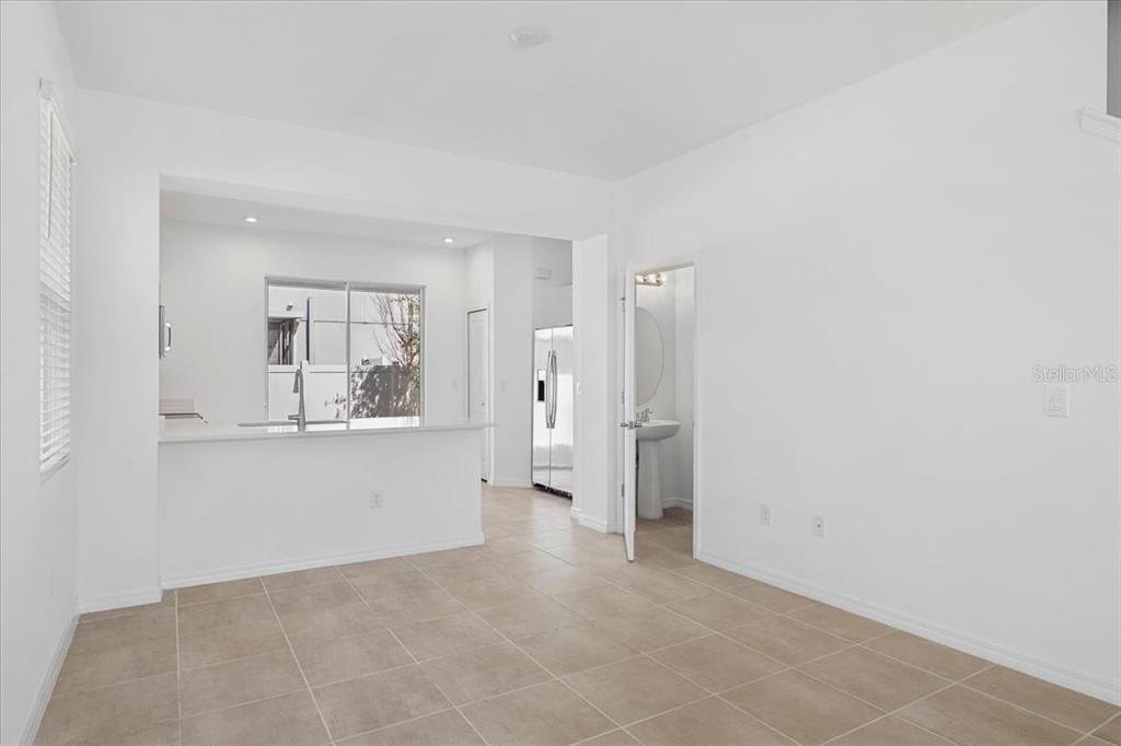 6338 Fairmont Lane Palmetto, FL 34221 - Photo 25 of 39 a view of a big room with wooden floor and a kitchen