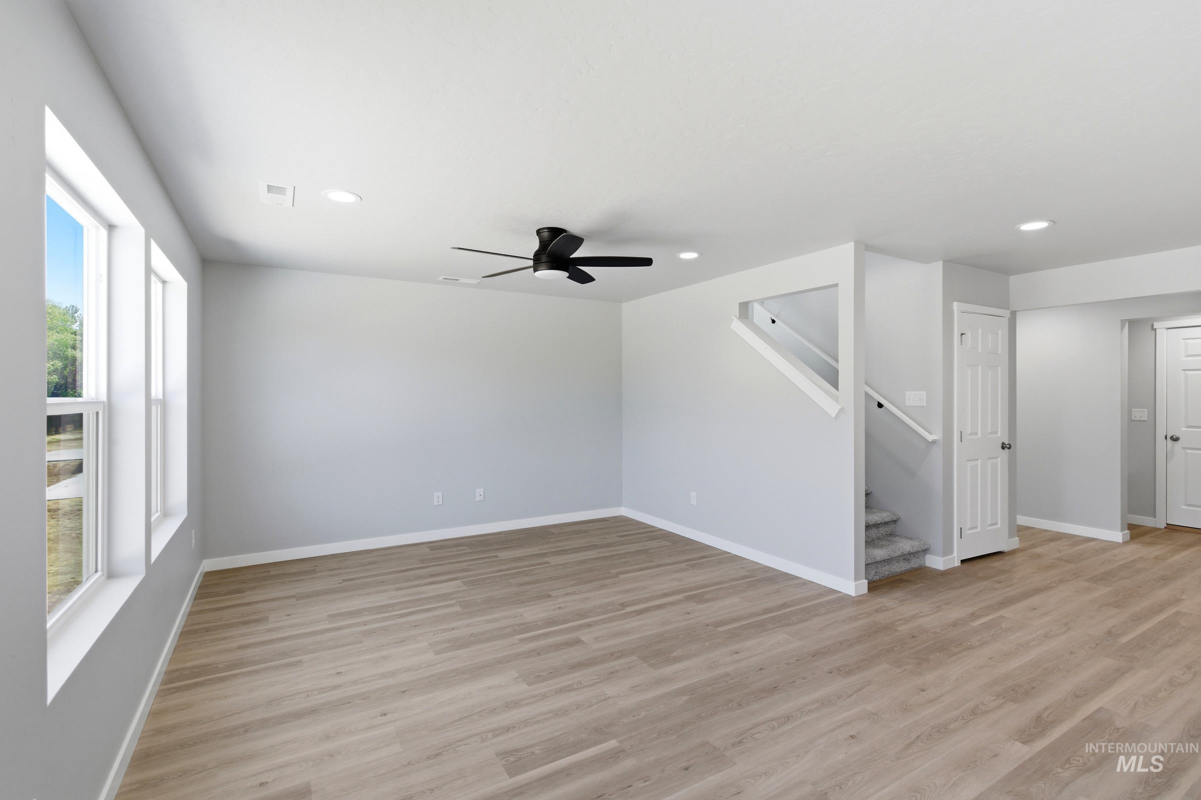 2374 West Fallon Loop Nampa, ID 83651 - Photo 9 of 24 Spacious interior featuring light wood-finish flooring, recessed lighting, and a modern ceiling fan