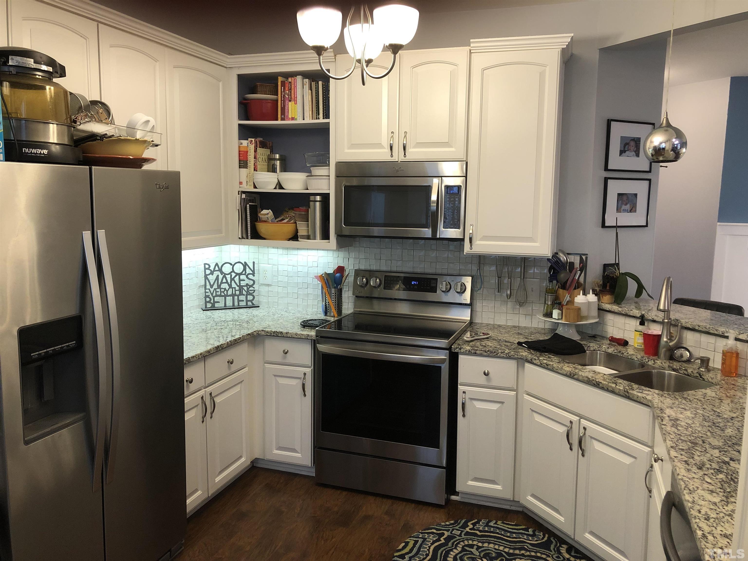437 Seastone Street Raleigh, NC 27603 - Photo 2 of 30 a kitchen with stainless steel appliances granite countertop a refrigerator sink and stove
