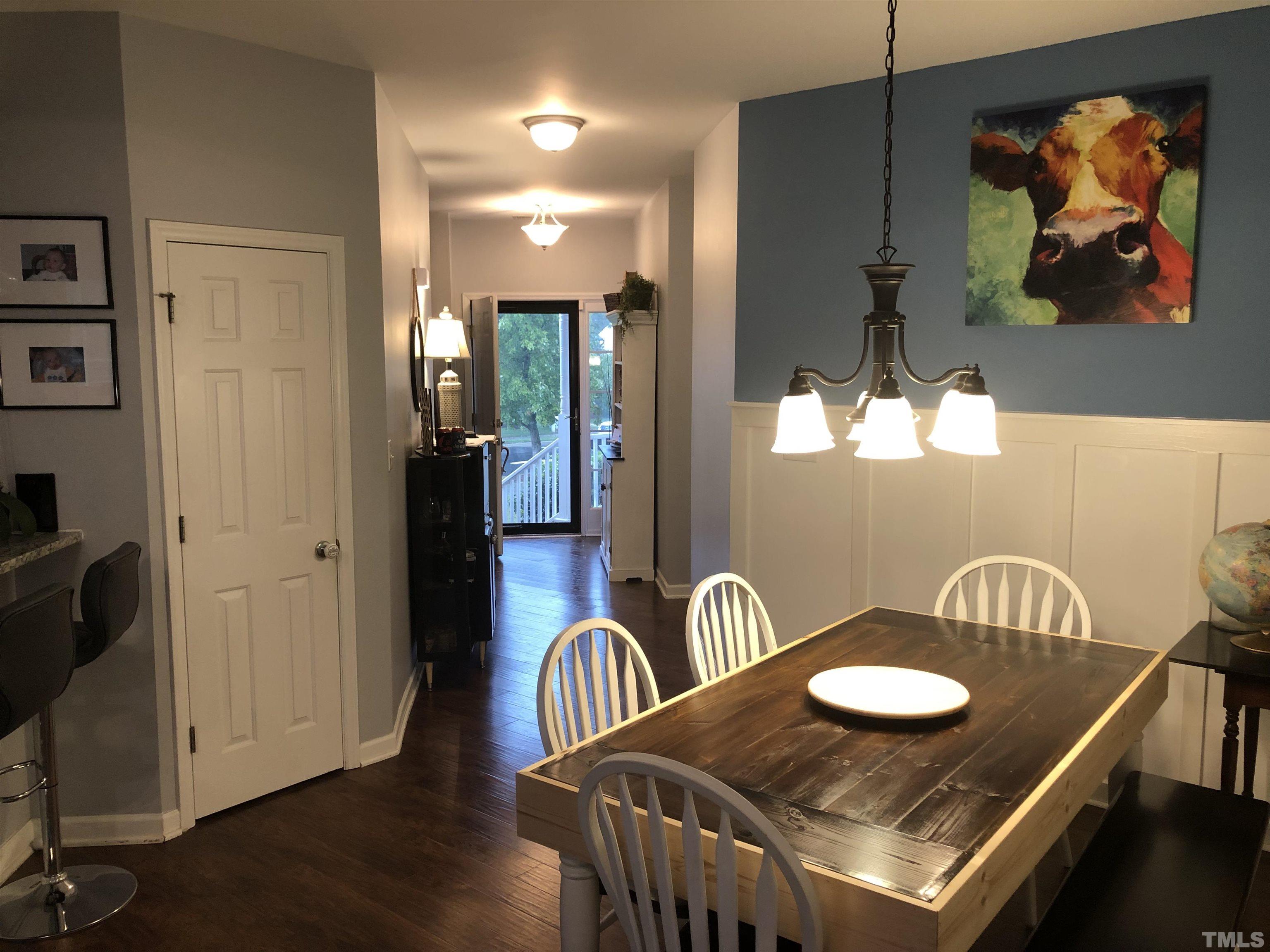 437 Seastone Street Raleigh, NC 27603 - Photo 12 of 30 a table and chairs in a dining room with wooden floor