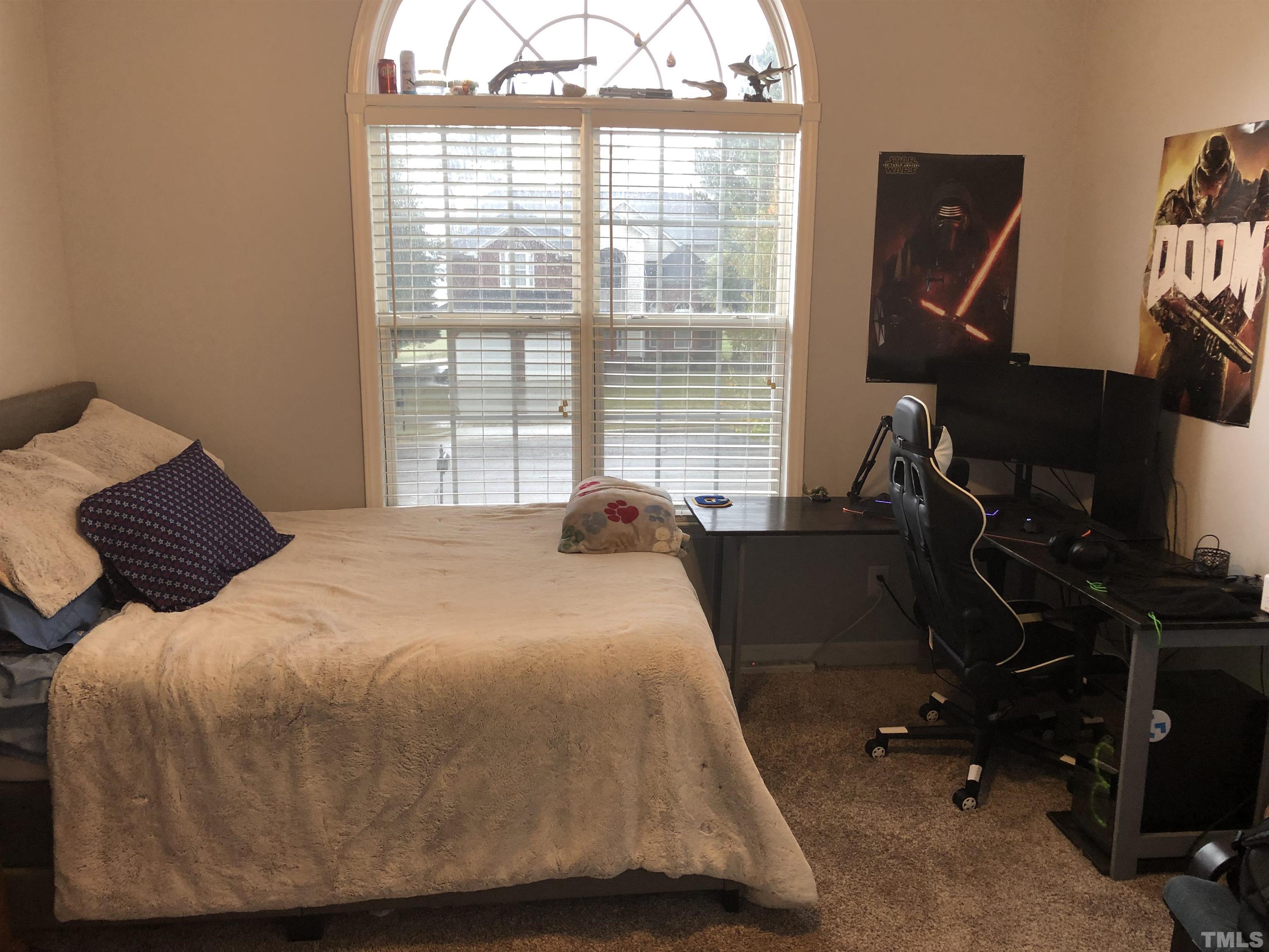 437 Seastone Street Raleigh, NC 27603 - Photo 19 of 30 a bedroom with a bed and wooden floor