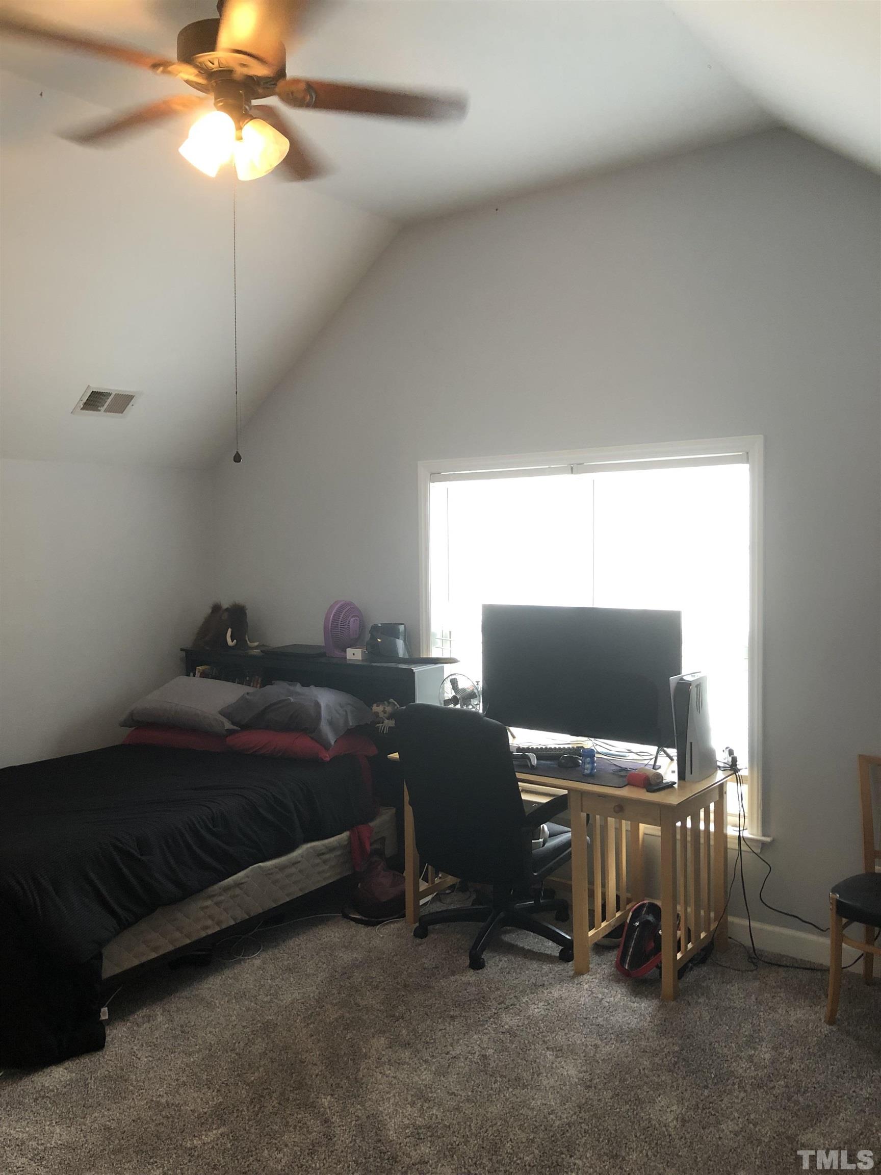 437 Seastone Street Raleigh, NC 27603 - Photo 24 of 30 a bedroom with a bed and a window