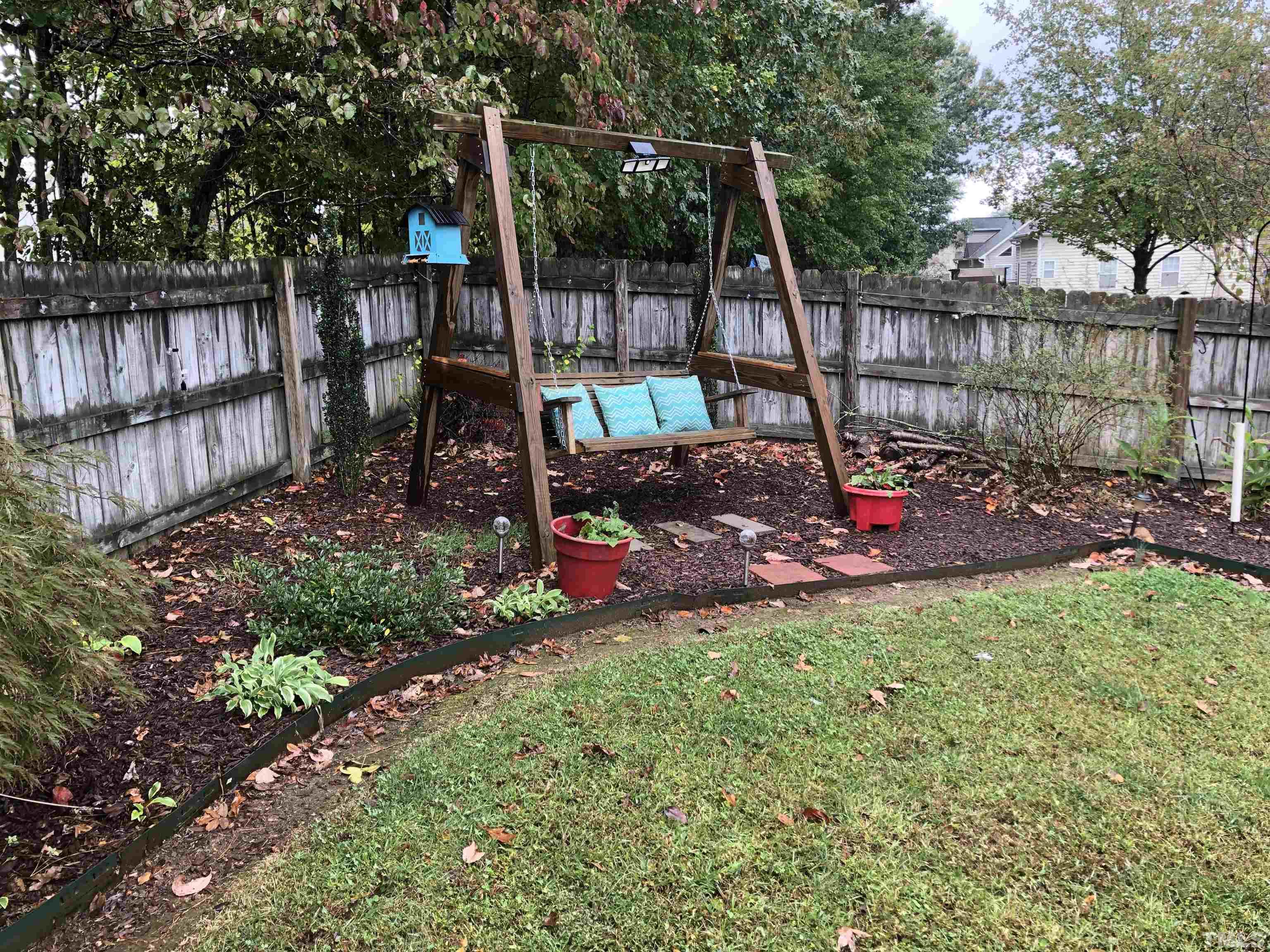 437 Seastone Street Raleigh, NC 27603 - Photo 25 of 30 a view of a backyard with sitting area and slide