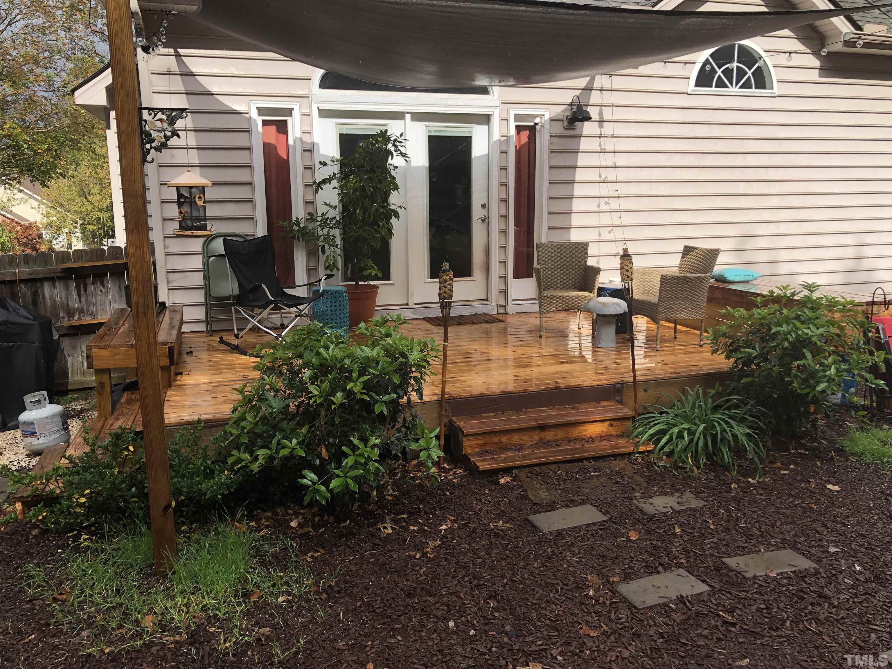 437 Seastone Street Raleigh, NC 27603 - Photo 28 of 30 a view of outdoor space yard deck patio and fire pit