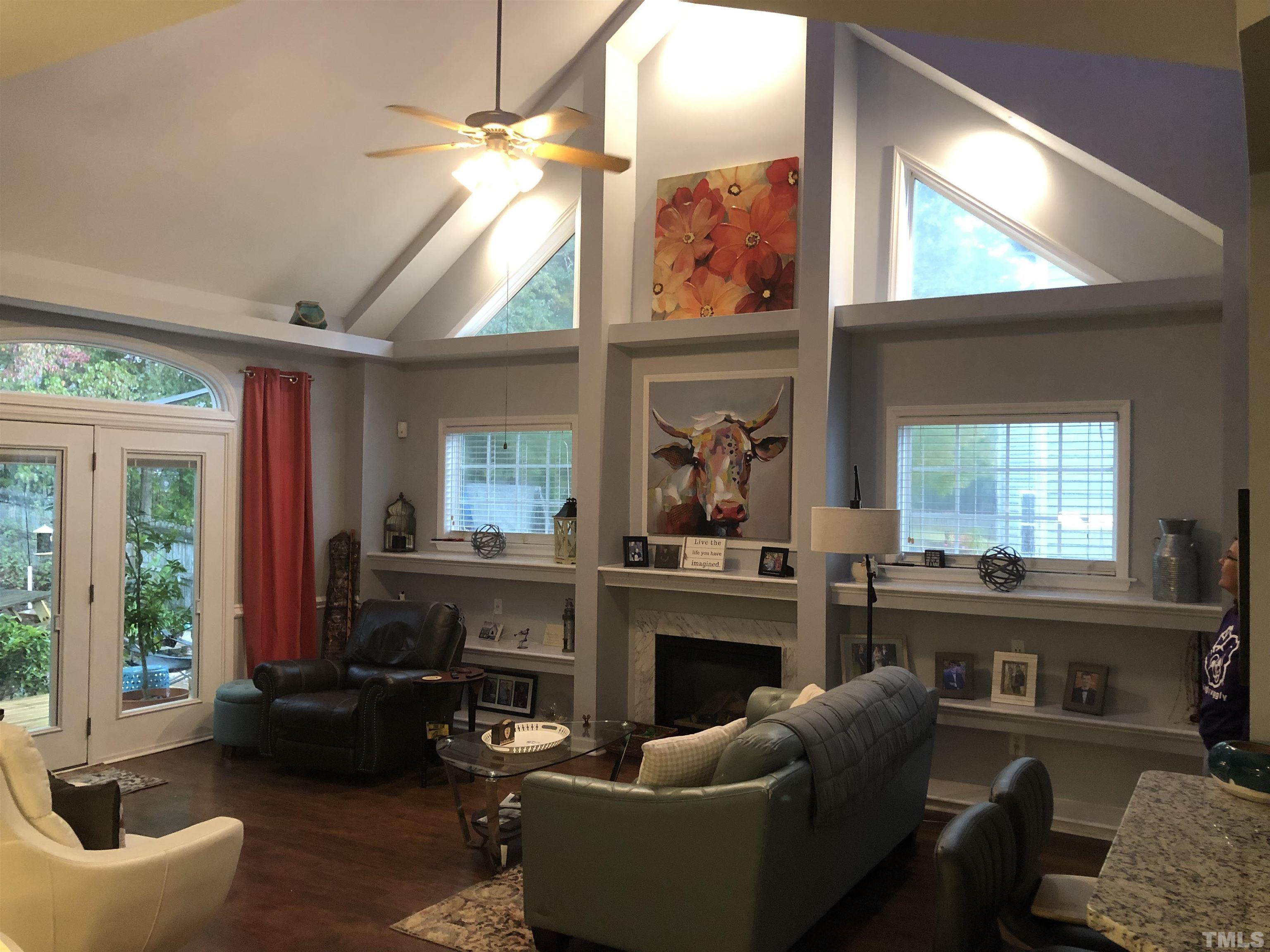 437 Seastone Street Raleigh, NC 27603 - Photo 5 of 30 a living room with furniture a large window and a fireplace