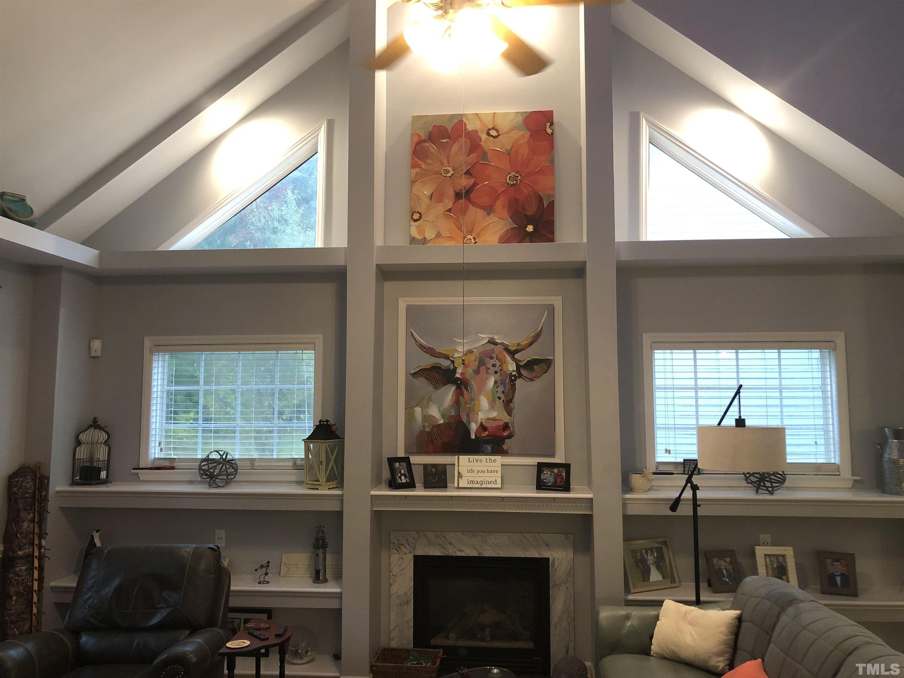 437 Seastone Street Raleigh, NC 27603 - Photo 6 of 30 a living room with furniture a fireplace and a large window