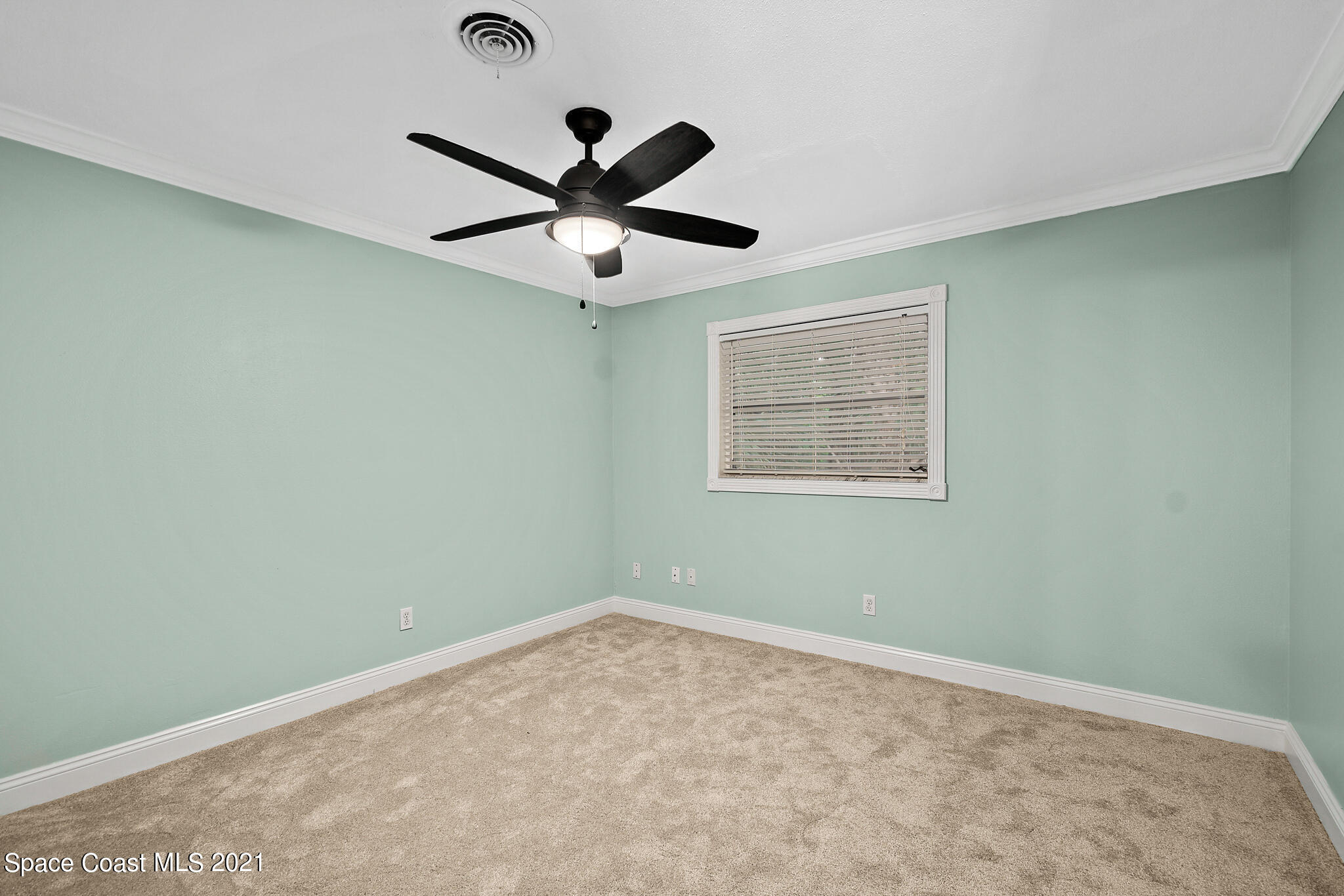 6686 Flamingo Road Melbourne Village, FL 32904 - Photo 23 of 30 an empty room with a window and a fan