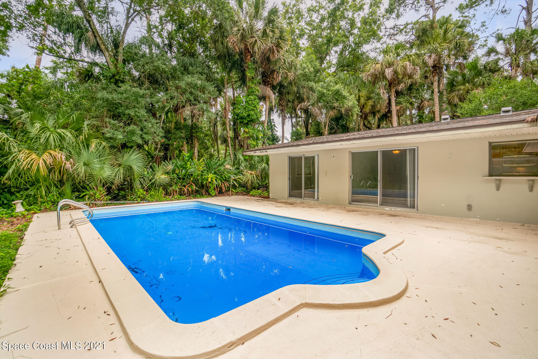 6686 Flamingo Road Melbourne Village, FL 32904 - Photo 26 of 30 a view of a swimming pool with an outdoor space