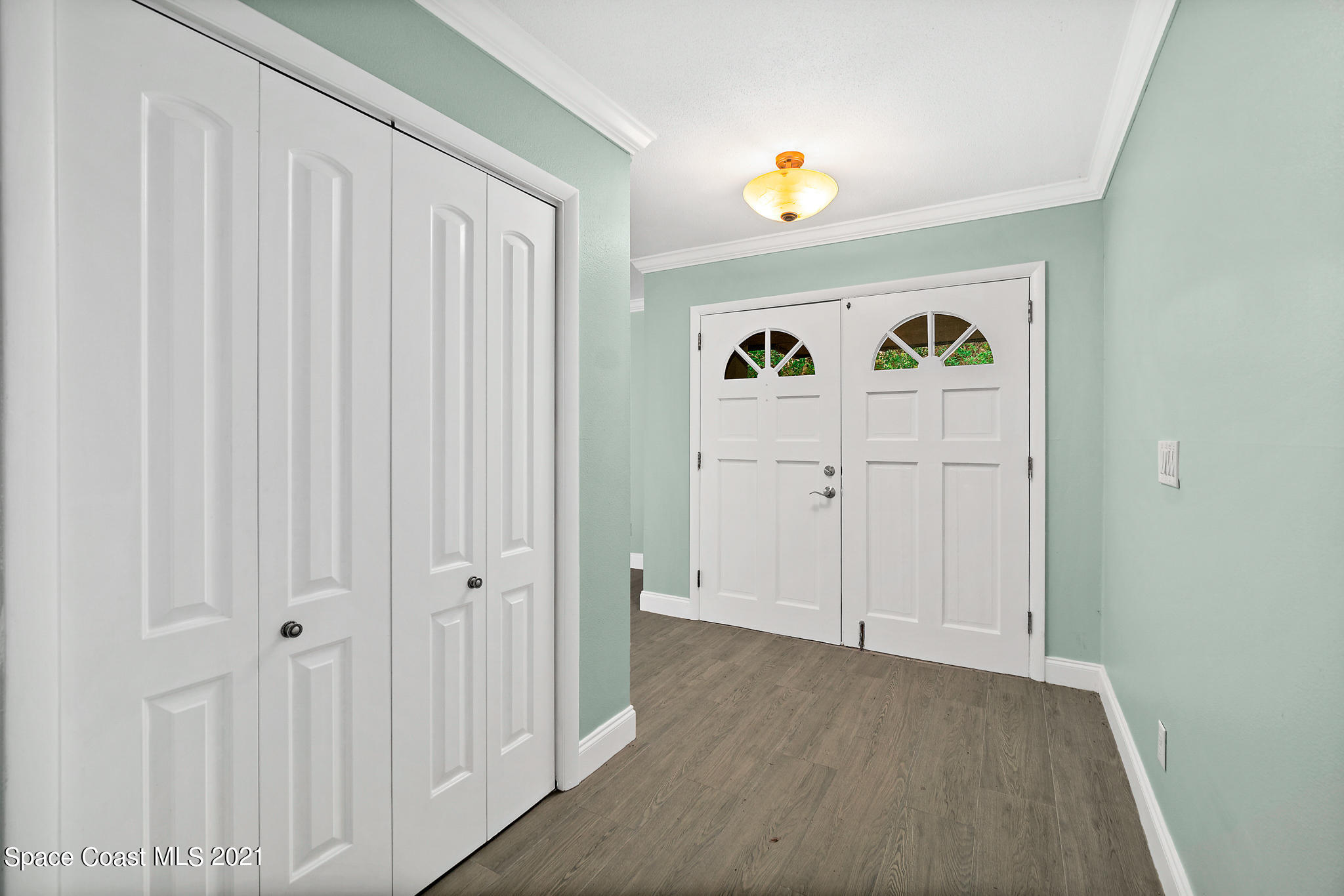 6686 Flamingo Road Melbourne Village, FL 32904 - Photo 6 of 30 a view of a hallway with wooden floor