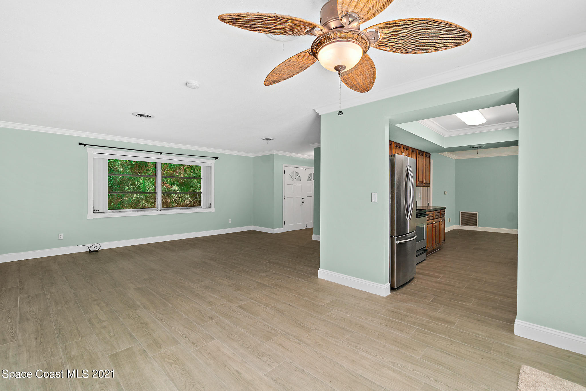 6686 Flamingo Road Melbourne Village, FL 32904 - Photo 7 of 30 wooden floor in an empty room with a window