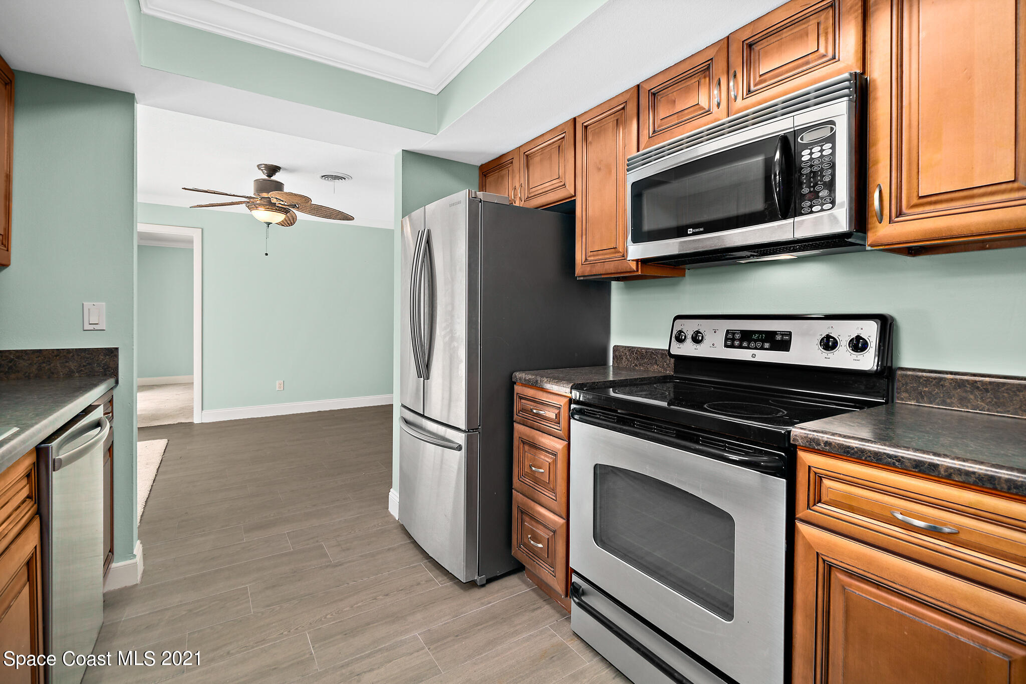 6686 Flamingo Road Melbourne Village, FL 32904 - Photo 9 of 30 a kitchen with stainless steel appliances a stove a microwave and a sink