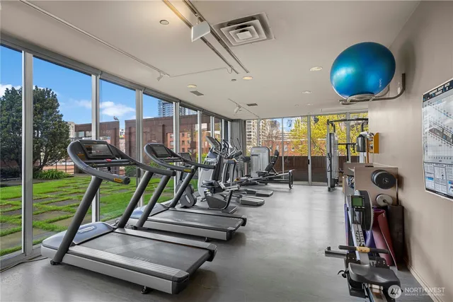 a room with gym equipment and large window