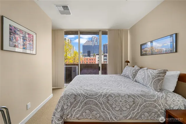 a bedroom with a bed and glass window