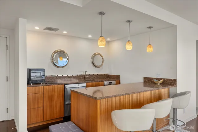 a bathroom with a granite countertop sink a mirror and vanity