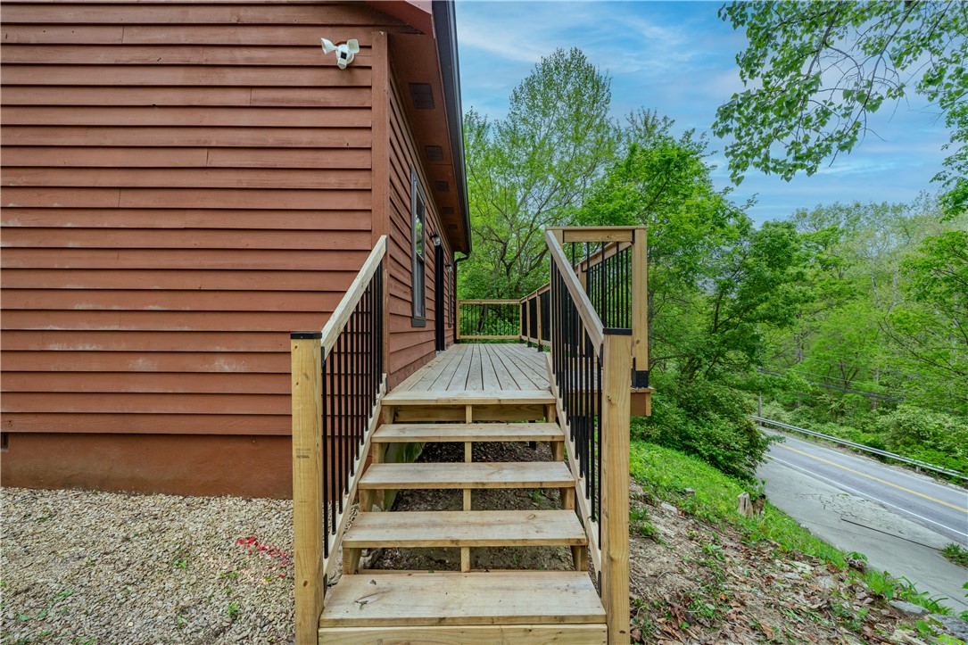 10584 New Biddinger Road Harrison, OH 45030 - Photo 43 of 61 This property features wood siding, a wooden deck, and a wooden porch with railings.