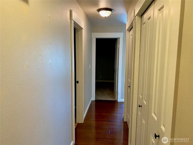 a bathroom with a toilet sink mirror and vanity