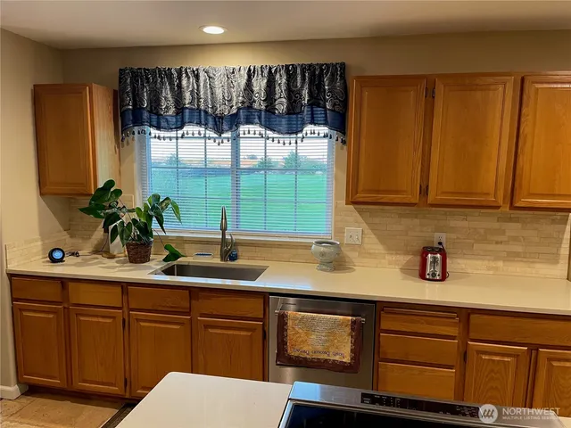a kitchen with a sink and large window
