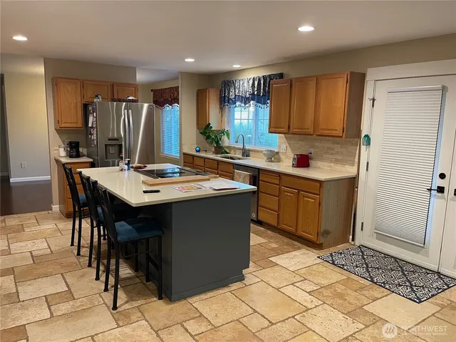 a kitchen with a sink a counter top space and stainless steel appliances