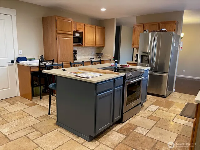 a kitchen with stainless steel appliances a sink and a refrigerator