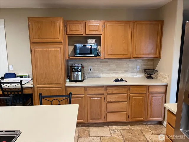 a kitchen with granite countertop a refrigerator stove and sink