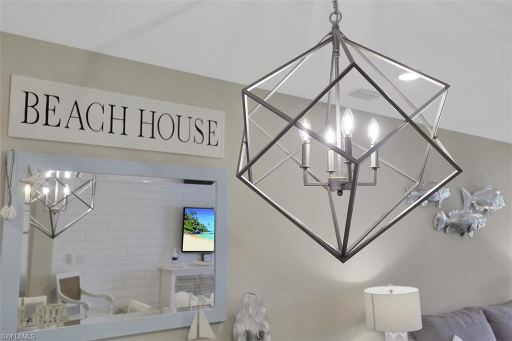 14663 Edgewater Circle Naples, FL 34114 - Photo 11 of 35 a view of staircase with white walls and a chandelier