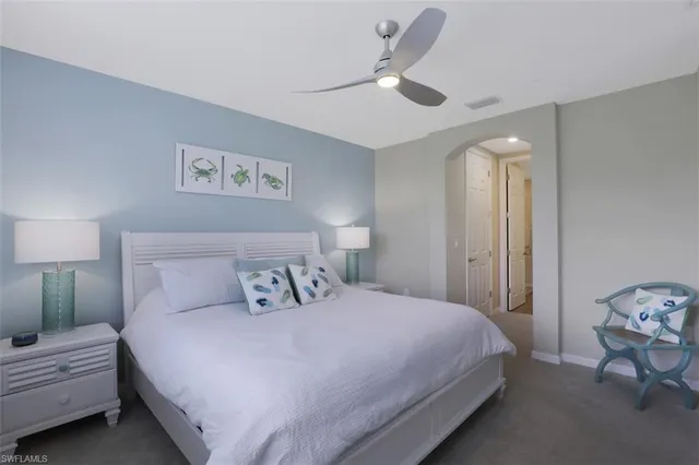 a bathroom with a granite countertop double vanity sink a toilet and a mirror