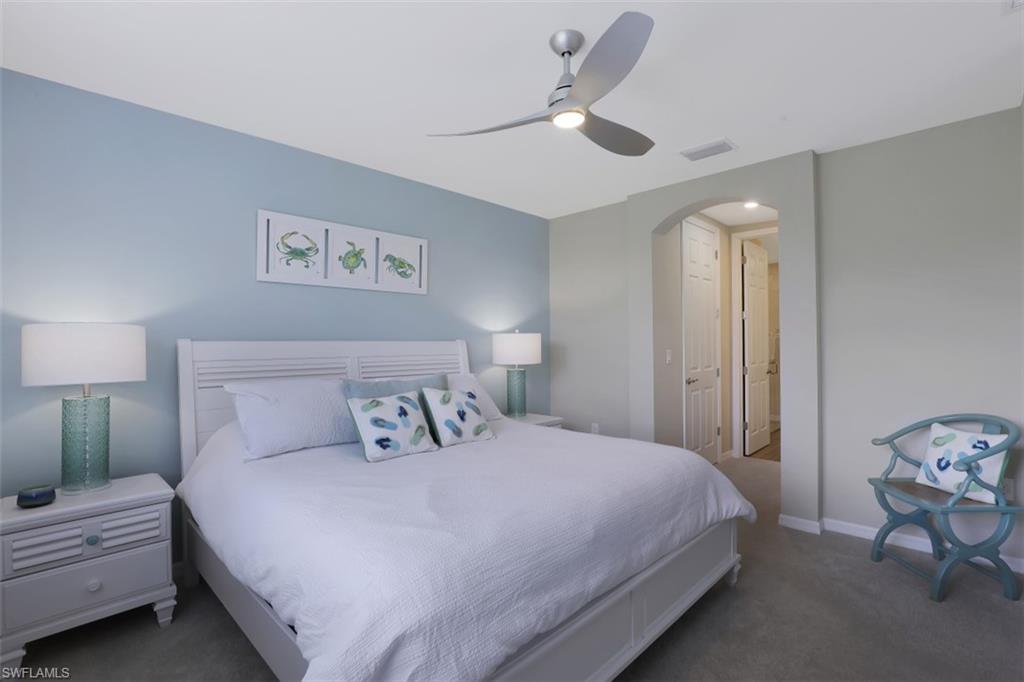14663 Edgewater Circle Naples, FL 34114 - Photo 14 of 35 a bedroom with a bed and a ceiling fan