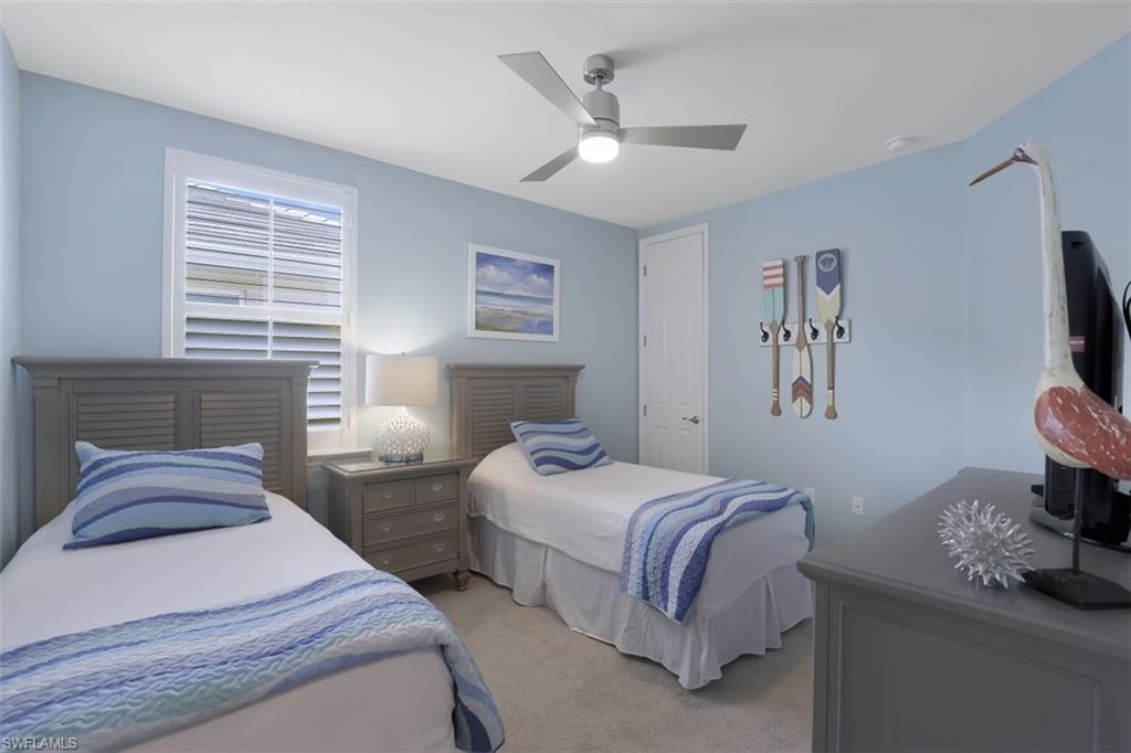 14663 Edgewater Circle Naples, FL 34114 - Photo 16 of 35 a bedroom with two beds and a window