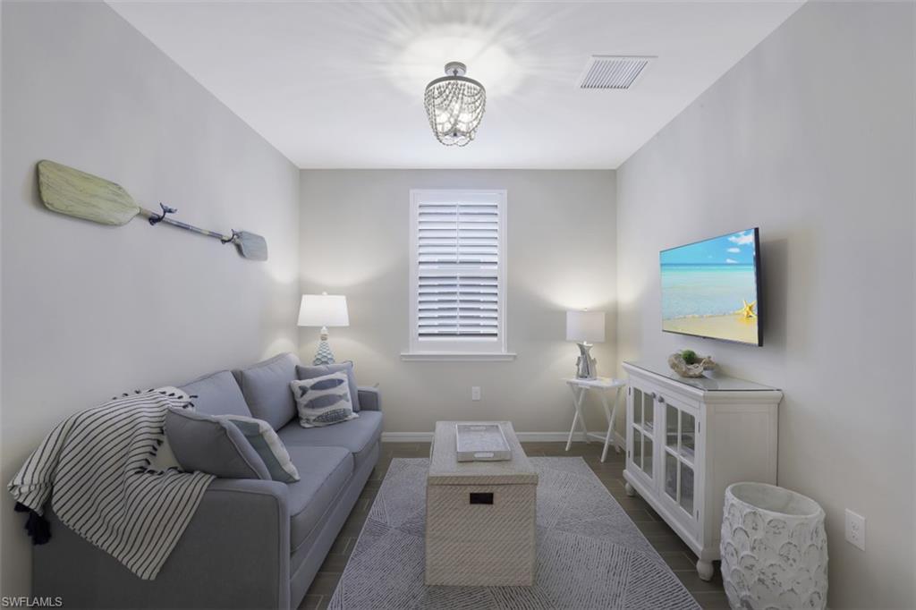14663 Edgewater Circle Naples, FL 34114 - Photo 18 of 35 a living room with furniture and a flat screen tv