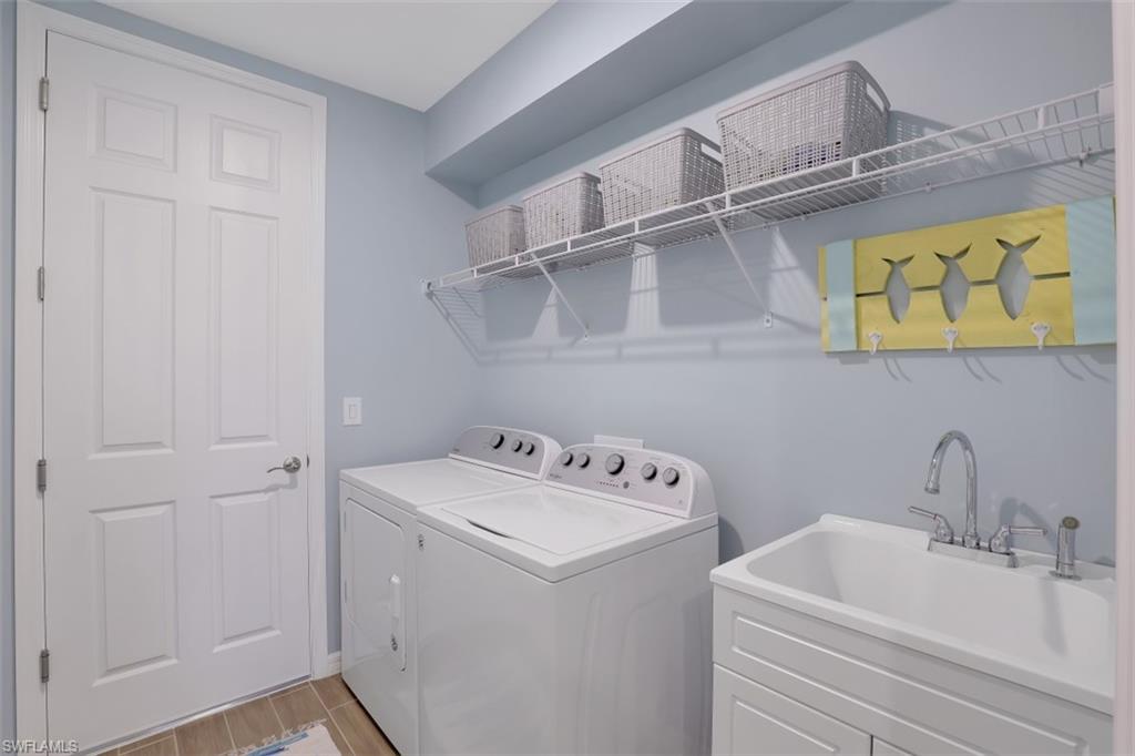 14663 Edgewater Circle Naples, FL 34114 - Photo 19 of 35 a bathroom with a sink and cabinets
