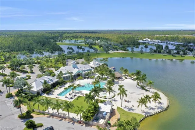 a view of a house with pool and chairs