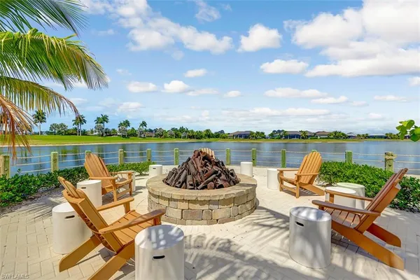 a view of a swimming pool and an outdoor seating