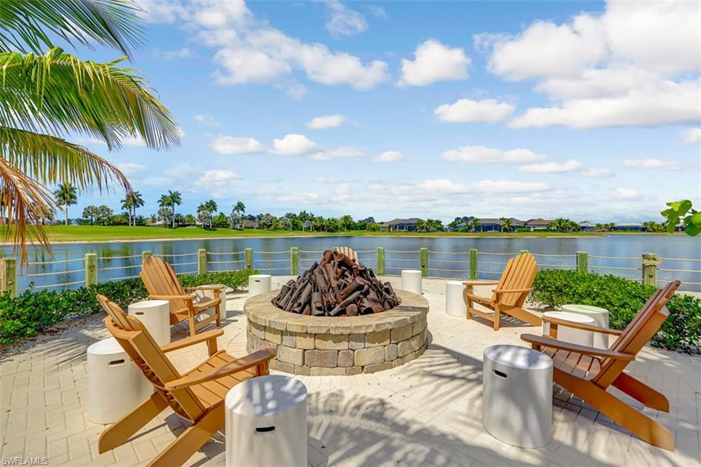 14663 Edgewater Circle Naples, FL 34114 - Photo 24 of 35 a balcony with furniture and a lake view