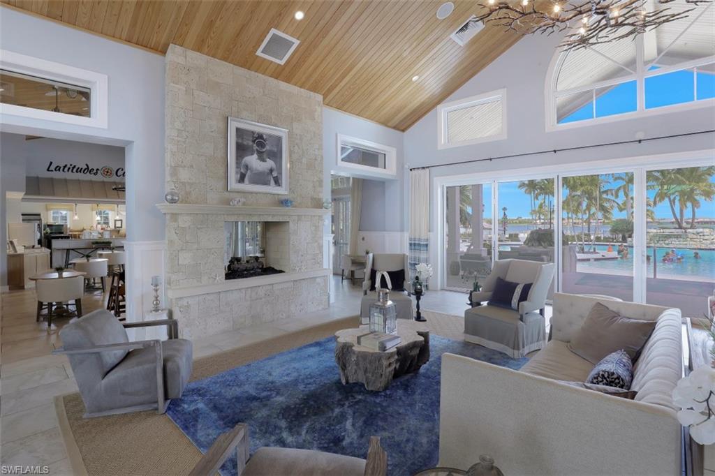 14663 Edgewater Circle Naples, FL 34114 - Photo 28 of 35 a living room with furniture and a fireplace