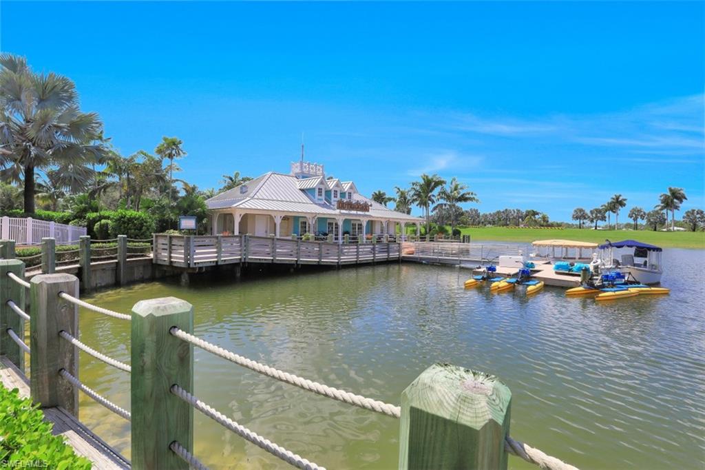 14663 Edgewater Circle Naples, FL 34114 - Photo 29 of 35 a view of a lake with a table and chairs