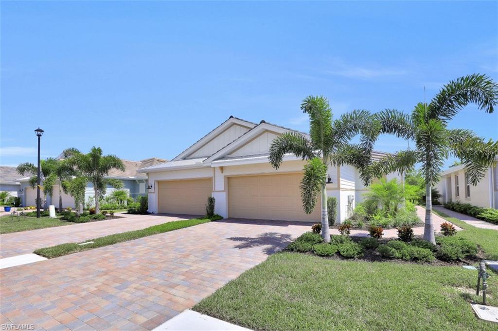 14663 Edgewater Circle Naples, FL 34114 - Photo 3 of 35 a front view of a house with a yard and garage