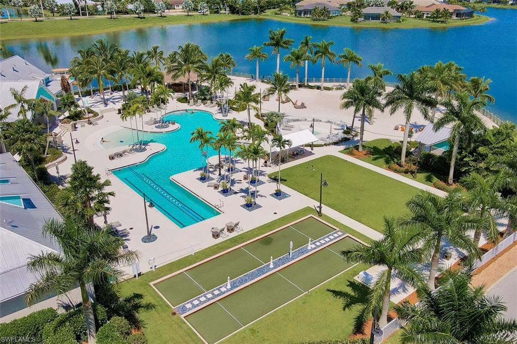 14663 Edgewater Circle Naples, FL 34114 - Photo 33 of 35 a view of a pool with a table and chairs