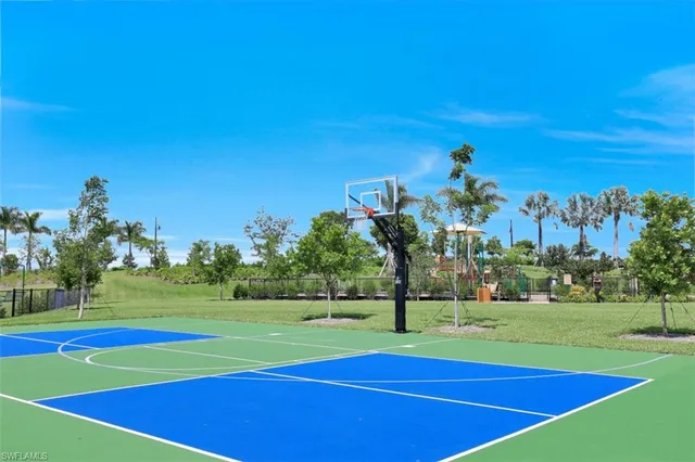 a front view of a house with a yard and potted plants