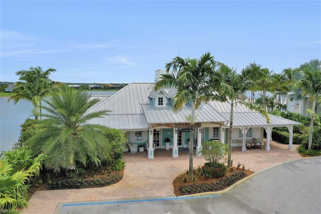 14663 Edgewater Circle Naples, FL 34114 - Photo 35 of 35 a front view of a house with a yard and potted plants