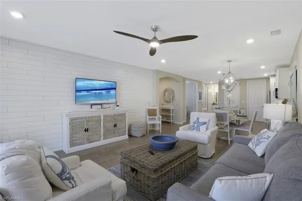 a living room with furniture and a wooden floor