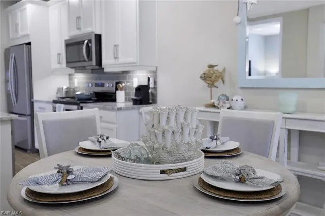 a view of staircase with white walls and a chandelier