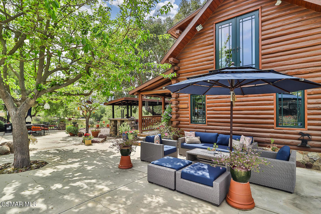 3030 Triunfo Canyon Road Agoura Hills, CA 91301 - Photo 11 of 50 a backyard of a house with barbeque oven table and chairs
