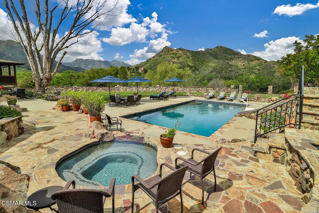 3030 Triunfo Canyon Road Agoura Hills, CA 91301 - Photo 12 of 50 a view of a swimming pool and lounge chair
