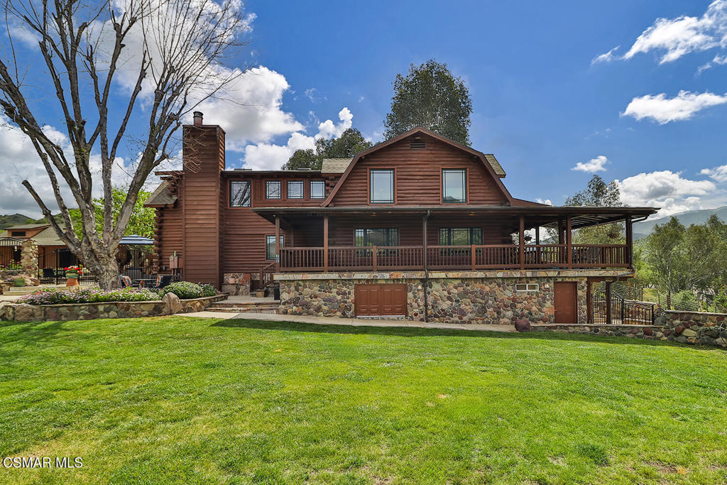3030 Triunfo Canyon Road Agoura Hills, CA 91301 - Photo 16 of 50 a front view of a house with a yard