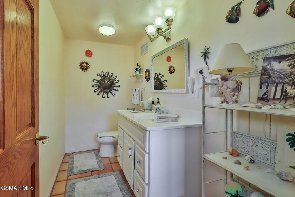 3030 Triunfo Canyon Road Agoura Hills, CA 91301 - Photo 27 of 50 a bathroom with a sink toilet and mirror