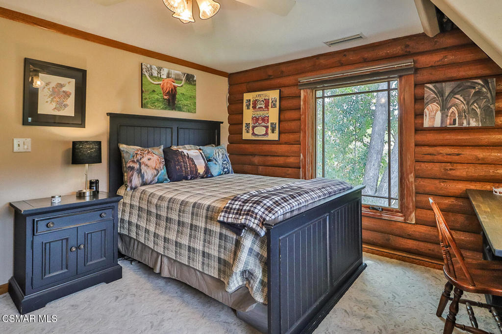3030 Triunfo Canyon Road Agoura Hills, CA 91301 - Photo 28 of 50 a bedroom with a bed and a dresser next to a window